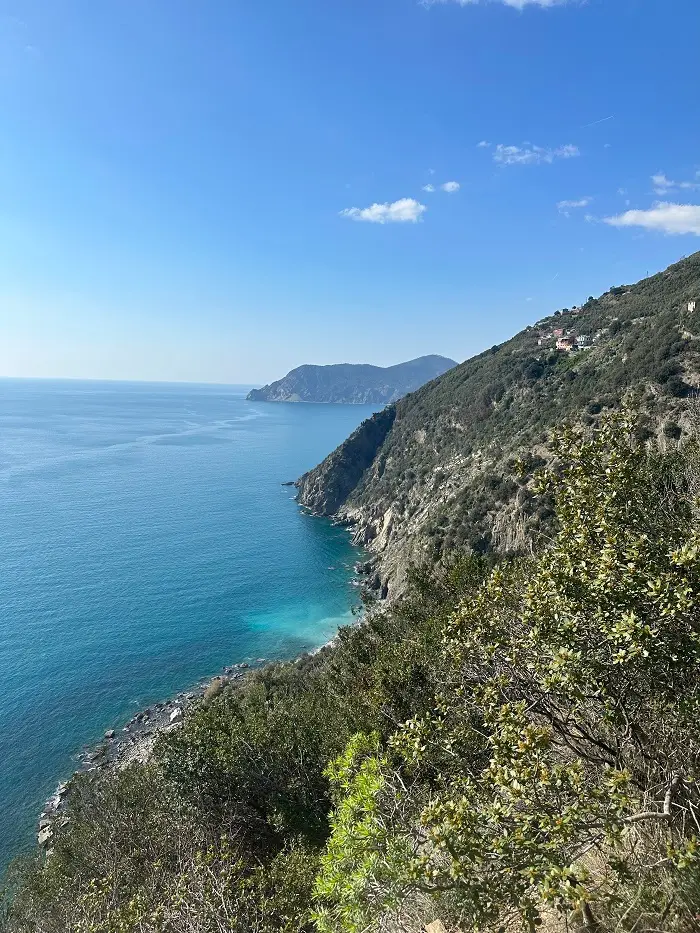 The ocean and side of a green mountain near Cinque Terre in Italy