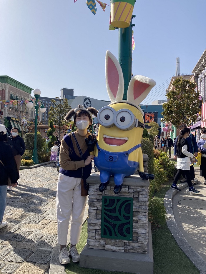A CET Japan student standing by a Despicable Me character in Japan's Universal Studio
