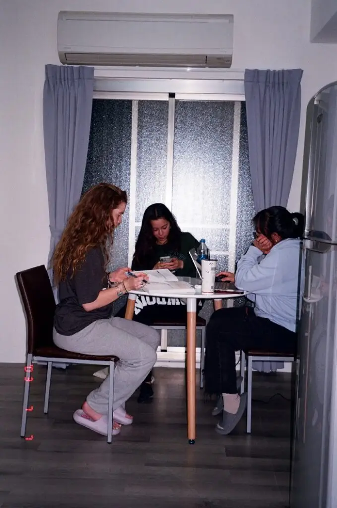 CET Taiwan roommates doing homework together in their apartment living room