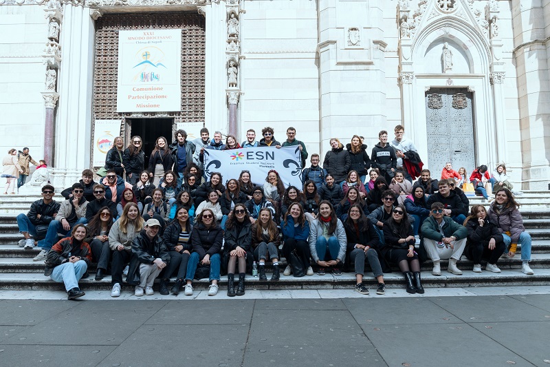 A large group of the Florence Erasmus group sitting and posing in front of the Naples Cathedral