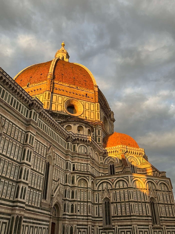 The outside of the Duomo building during sunset