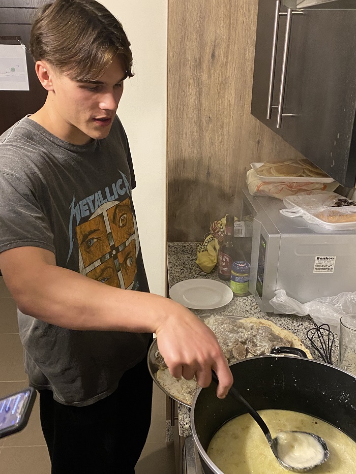 A CET Jordan student cooking in an apartment
