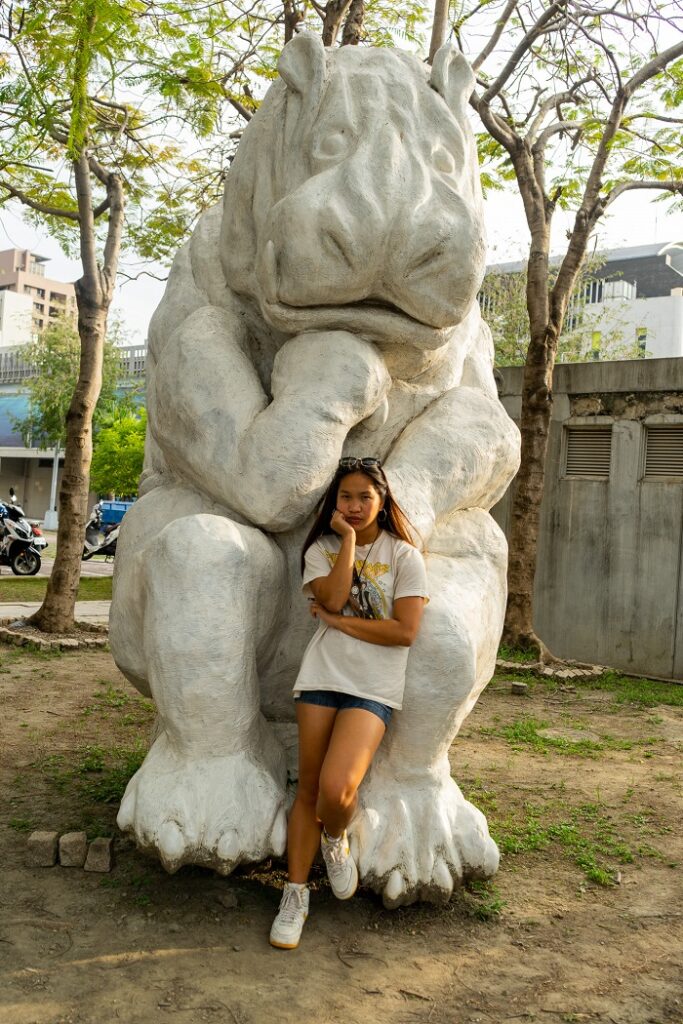 A CET Taiwan student posing in front of a giant hippo sculpture in Taichung Cultural Heritage Park