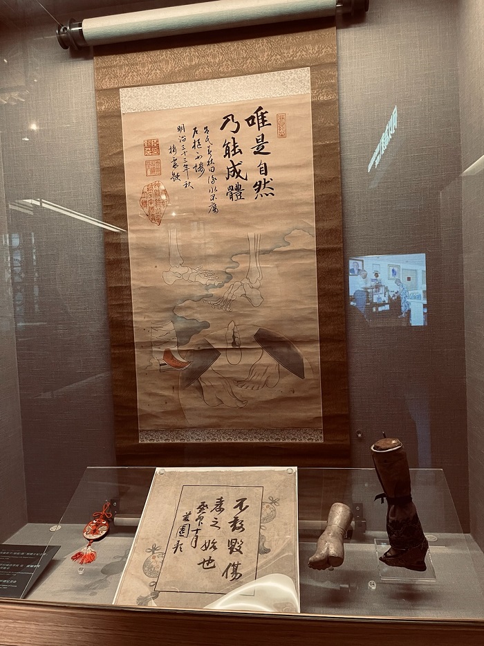 Artifacts such as a scroll inside a glass case within the National Taiwan Museum