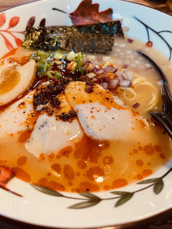 Ramen noodle bowl with seaweed, hot oil, and egg