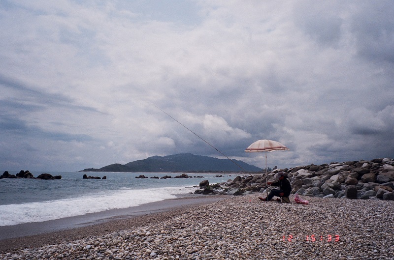 A fisherman sitting near the waters at Hualien beach in Taiwan