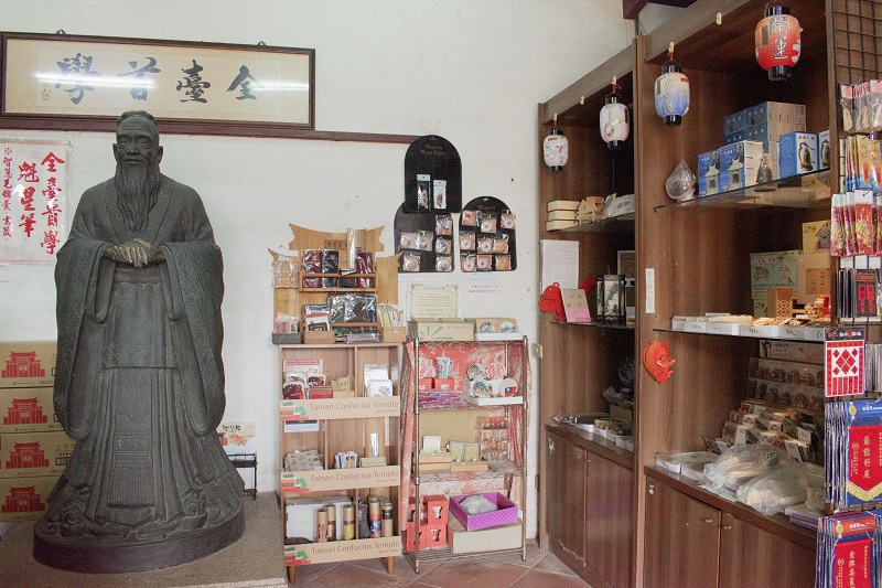 A statue of Confucius on the left and some of the goods for sale in the Tainan Confucius Temple’s store