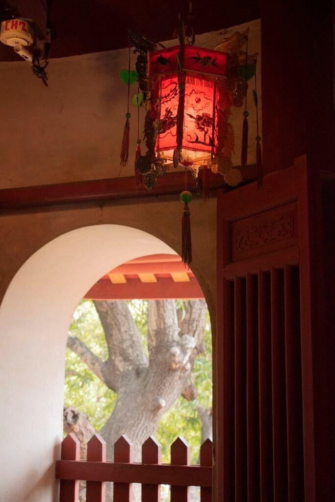 A red lantern hanging on the 3rd floor of a pagoda by the Tainan Confucius Temple