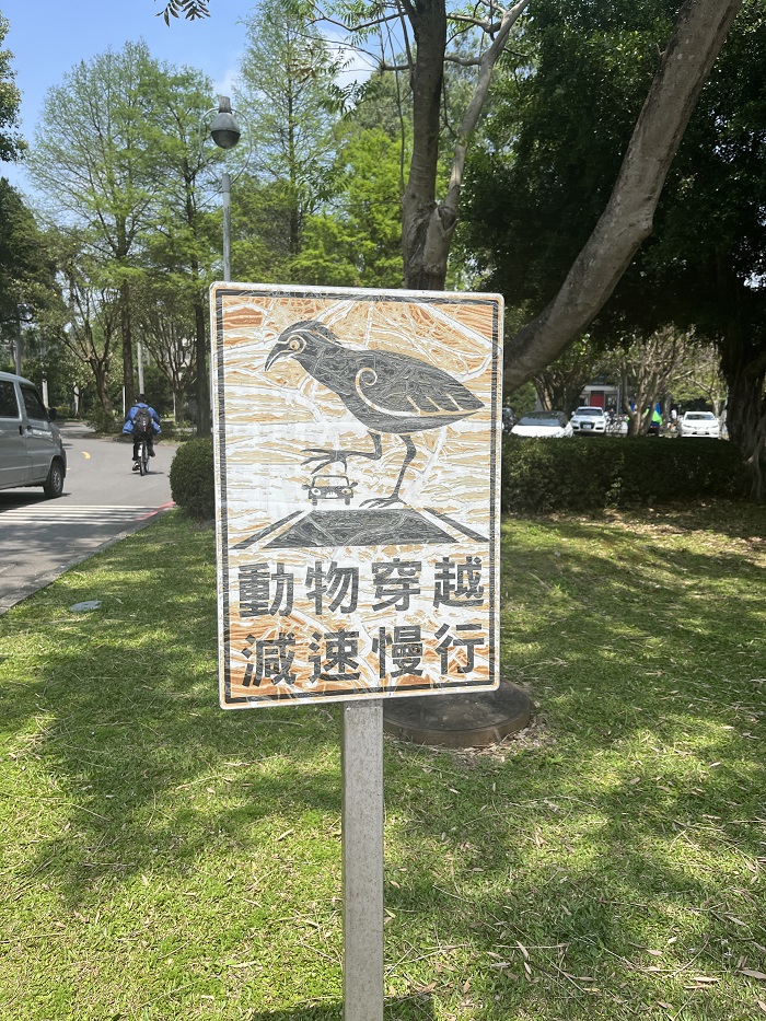 A sign with a bird about to stomp on a car in National Taiwan University’s campus