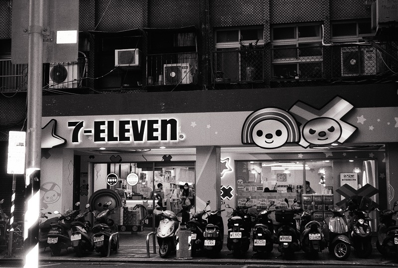 People shopping inside of a cartoon-themed 7-Eleven in Taiwan