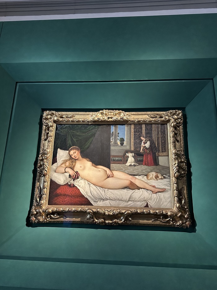 "Venus of Urbino" by Titian artwork in the middle of a wall in the Uffizi Gallery in Florence, Italy