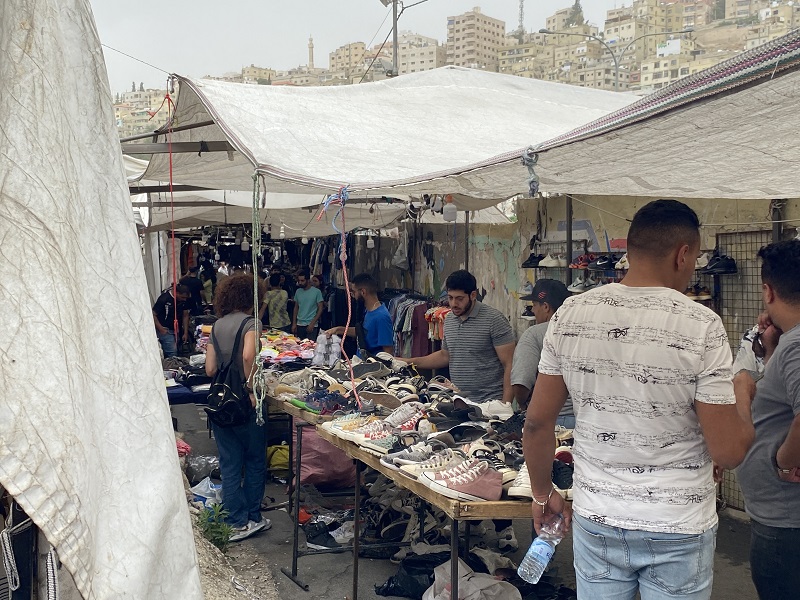 People shopping and selling items at a Friday Market in Jordan