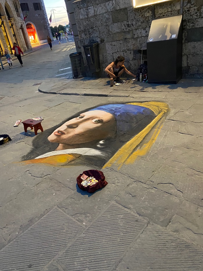 Somebody used chalk to draw the Girl with a Pearl Earring art on the street in Siena