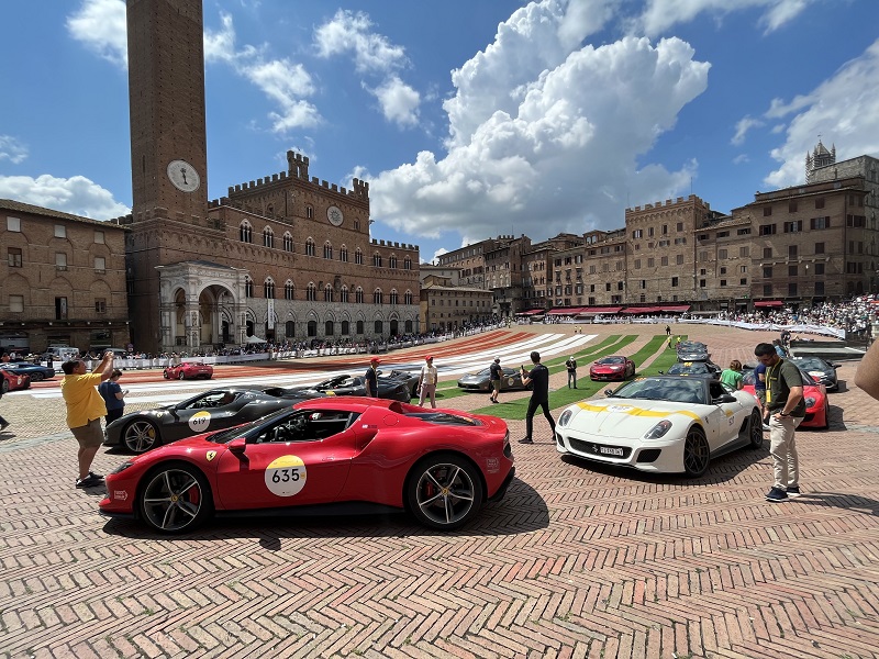 Historic cars driving through Piazza del Campo for the 1000 miles event in Siena, Italy
