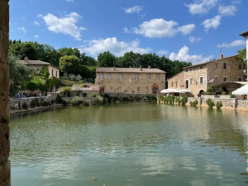 A empty hot spring within Bagno Vignoni in Italy on a partly cloudy day