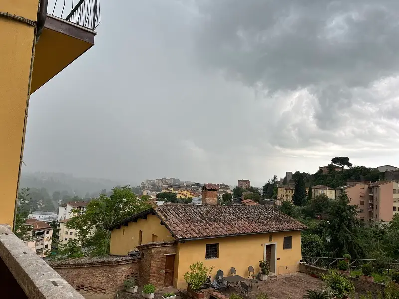 The view from a CET Siena apartment as a storm approaches from outside the city walls