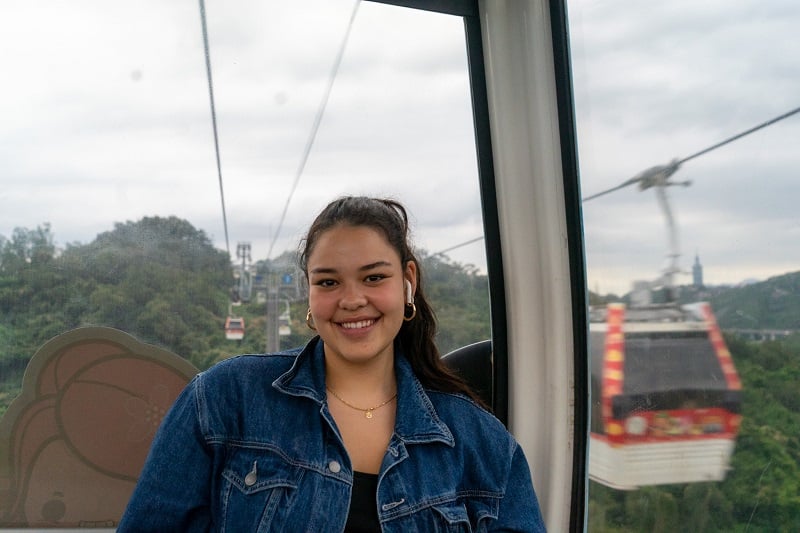 A CET Taiwan student smiling inside of a Maokong Gondola in Taiwan