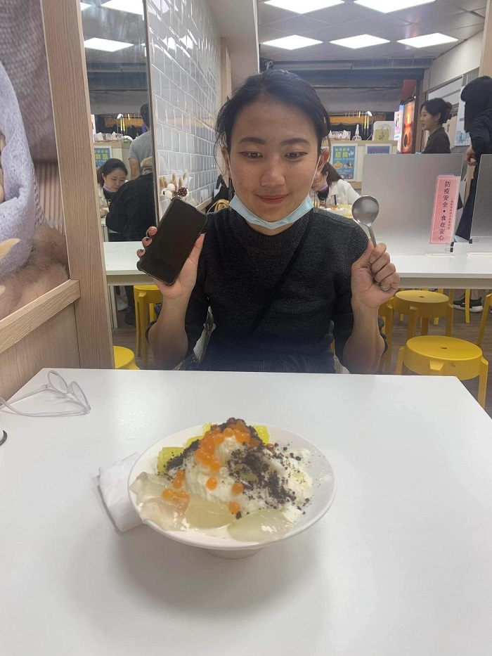 A CET Taiwan language partner staring intently at a shaved ice dessert in Taiwan