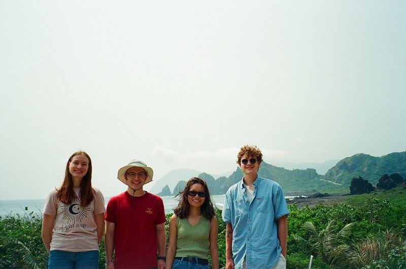 Four CET Taiwan students, two girls and two boys, smiling on Orchid Island on a bright and clear day