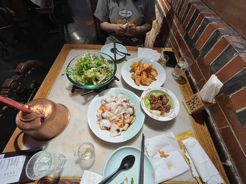 A bird-eyes view of a dinner table with vegetables and other Chinese dishes