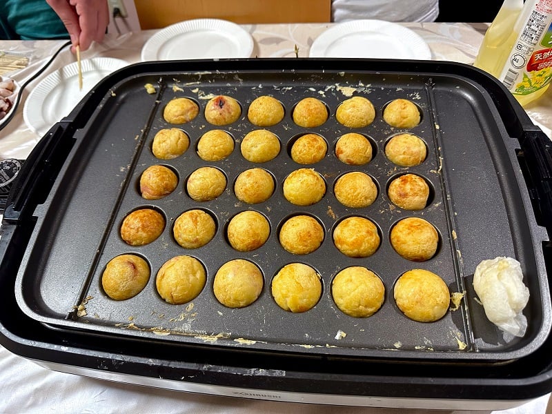 Close up of Takoyaki being made in a Takoyaki-making pan