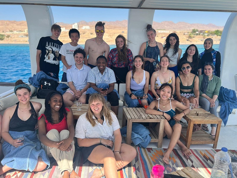 CET Jordan cohort in bathing suits and sitting on a boat while on the Red Sea