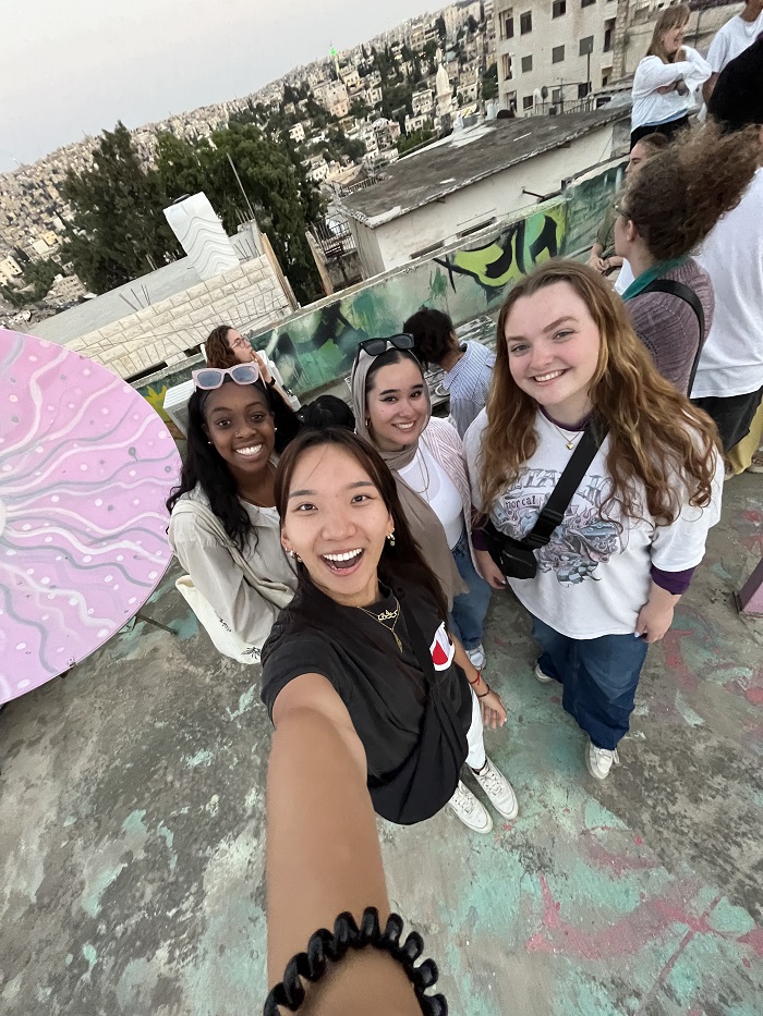 A 0.5 selfie of four CET Jordan students on the rooftop of a community art space called House of Dreaming in Jordan