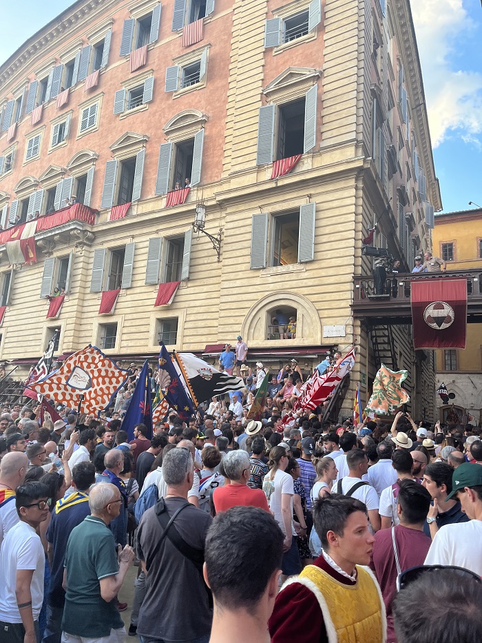 Aftermath of the Palio di Siena race with people singing and celebrating the victory outside