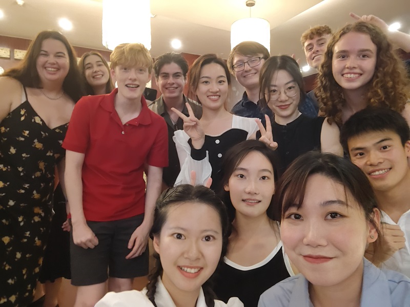 A group photo taken of CET Beijing students and friends indoors