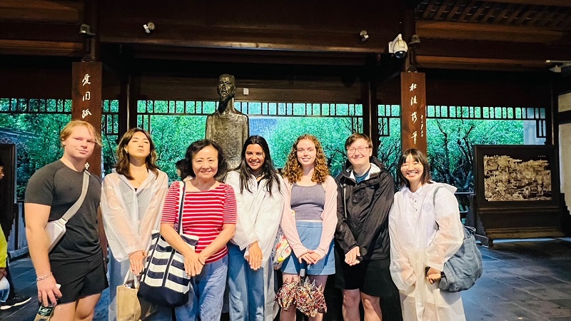 A small group of CET Beijing students under the cottage of Du Fu in Chengdu, China