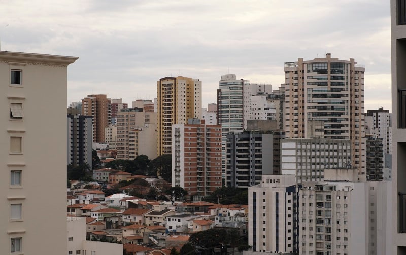 View of city buildings and homes from a rooftop during sunset in Brazil
