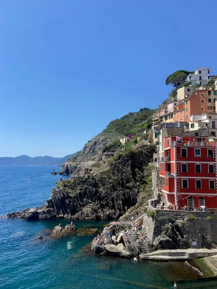 Houses on the edge of the coast along the cliffside in Cinque Terre, Italy
