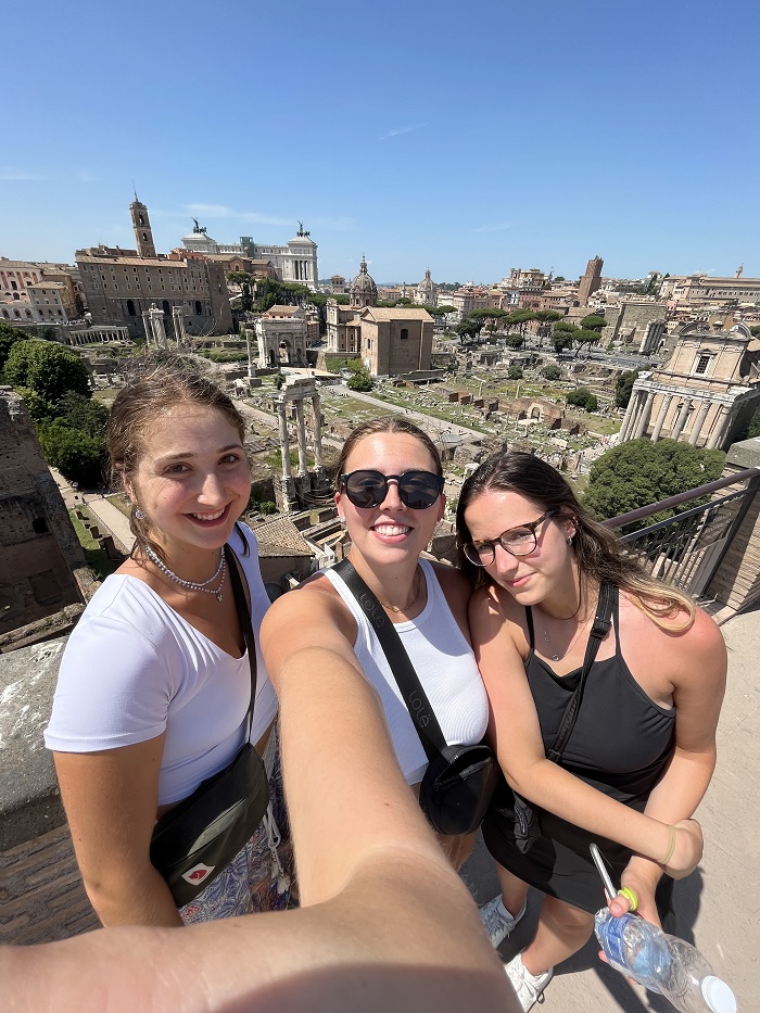 Three CET Siena students standing in front of the Roman Forum in Rome, Italy on a clear day