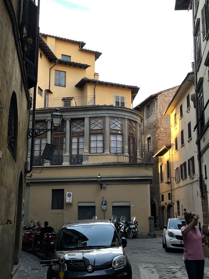 The exterior of an apartment building on a street in Florence, Italy