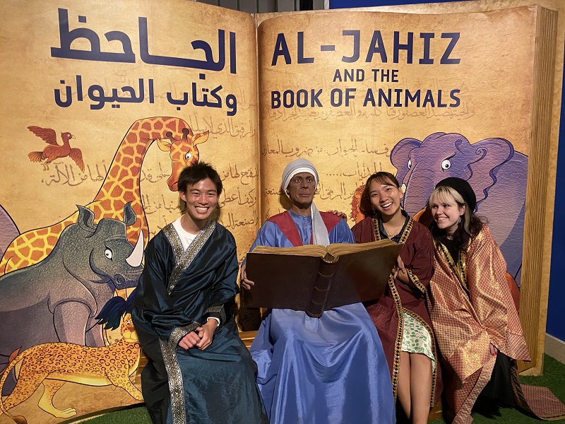 CET Jordan students in the Jordan Museum sitting by the Al-Jahiz and the Book of Animals exhibit