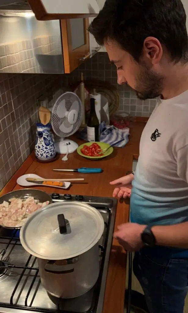 A CET Siena roommate cooking in the kitchen