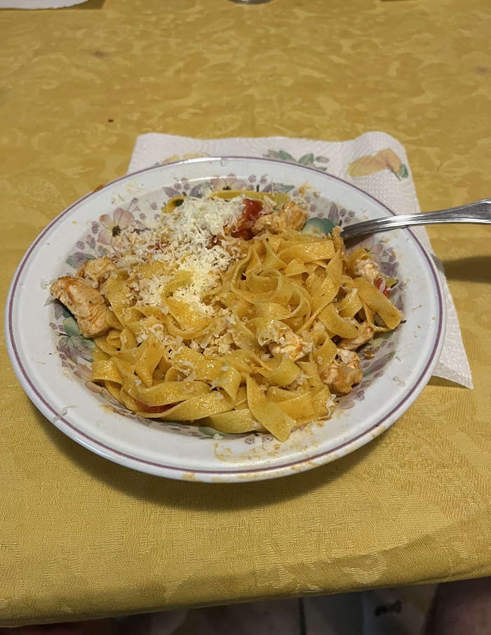 A dish of home cooked pasta with a fork in it