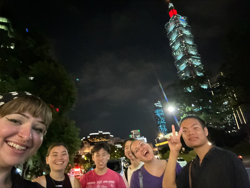CET Taiwan housemates standing by Taipei 101 at night