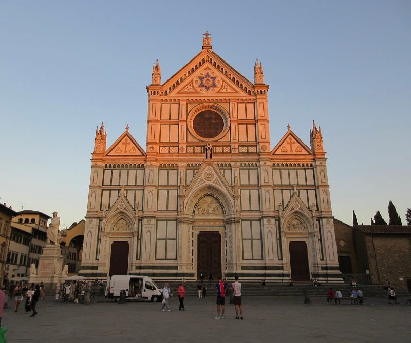 People standing around Piazza Santa Croce in front of the basilica