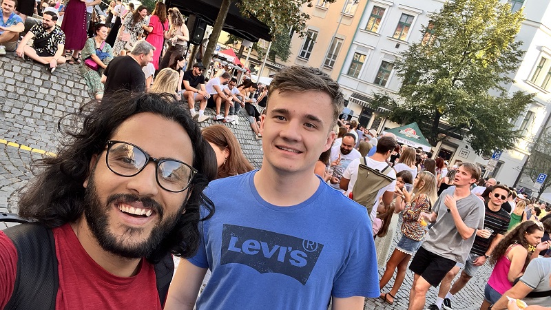 A CET Film Production at FAMU student and his Czech roommate at a Mexican street festival in Prague with many people in the background