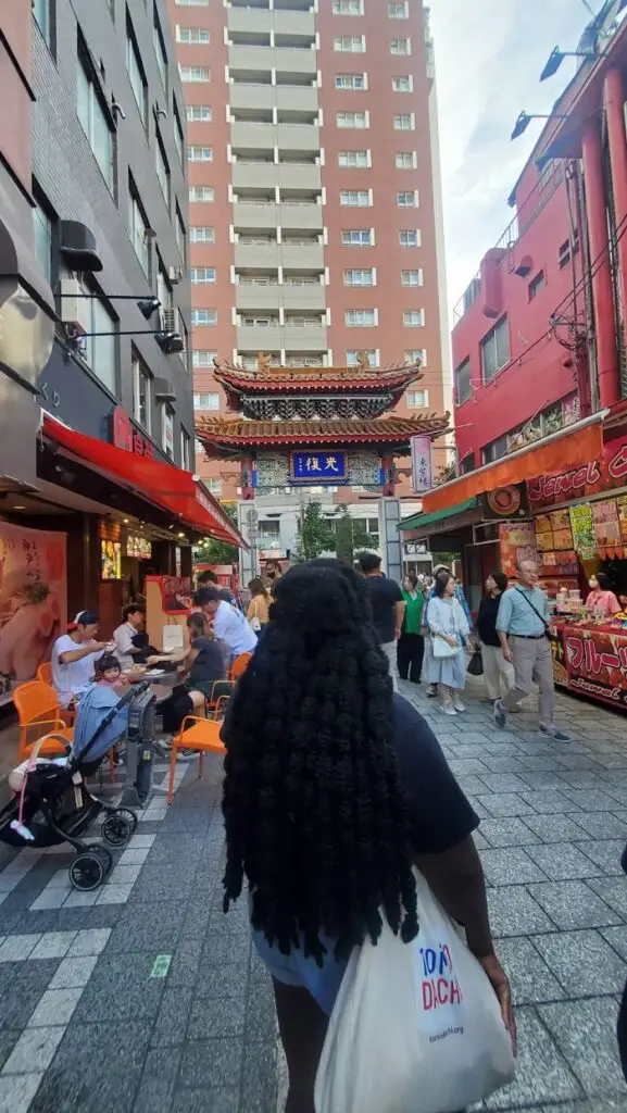 A female CET Japan student standing in the middle of a street in Kobe, Japan