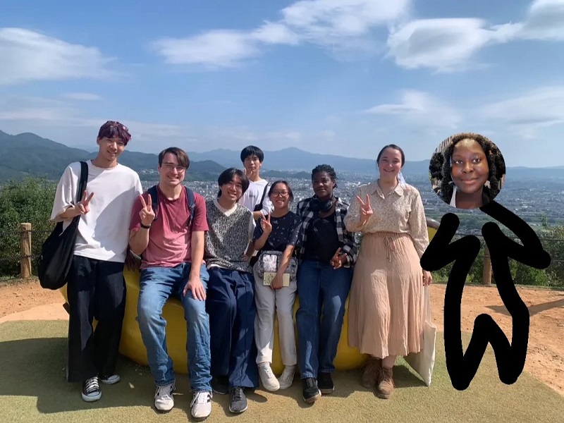 A group of some CET Japan students with one of the students photoshopped into the image on the far right with a scenic view in the background