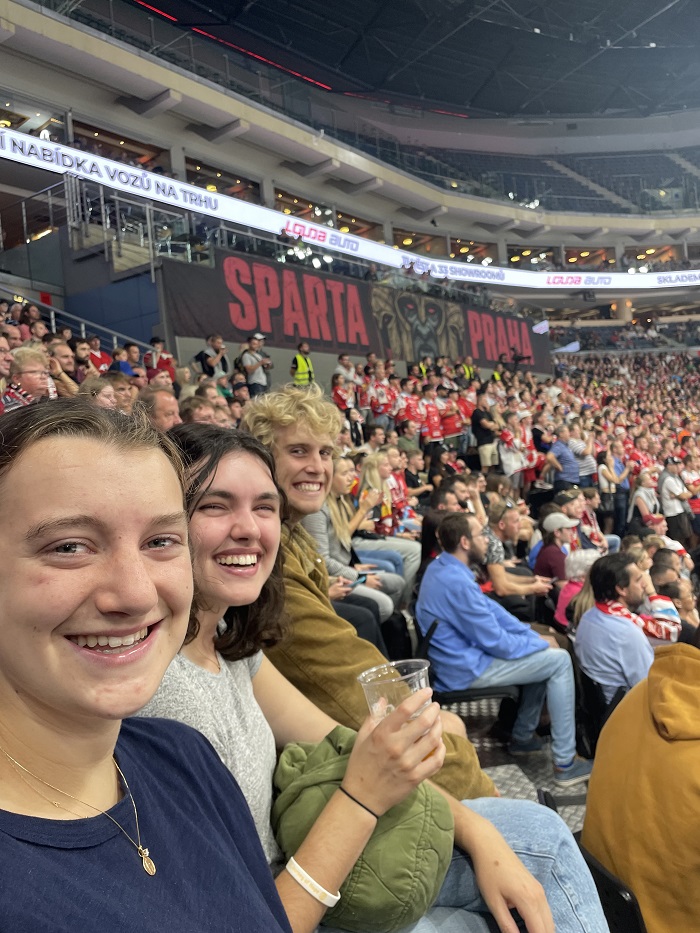 CET Prague students smiling while watching a hockey game in Prague