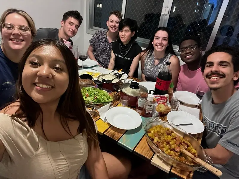 A group of CET Brazil Social Justice students sitting around a table with food