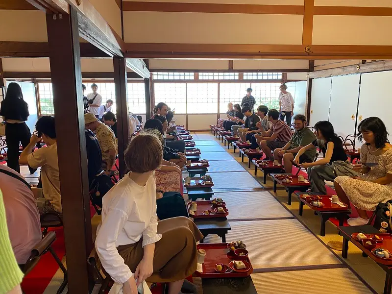 CET Japan students sitting on the floor with individual tables with vegetarian meals