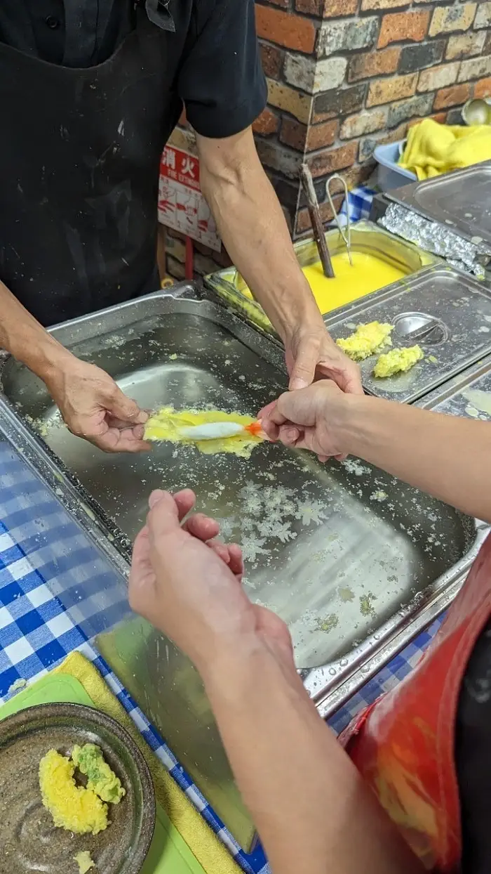 Two hands working together to make plastic foods