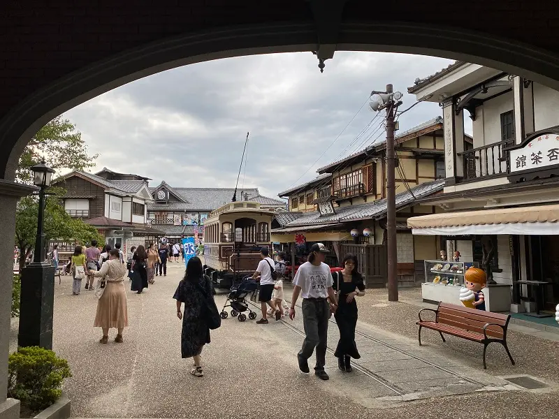 People walking around Toei Kyoto Studio Park in Japan on a cloudy day