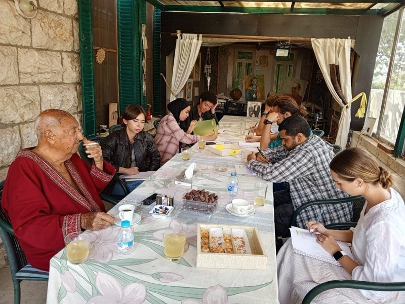 CET Jordan students writing on notebooks at a long table with a Duke