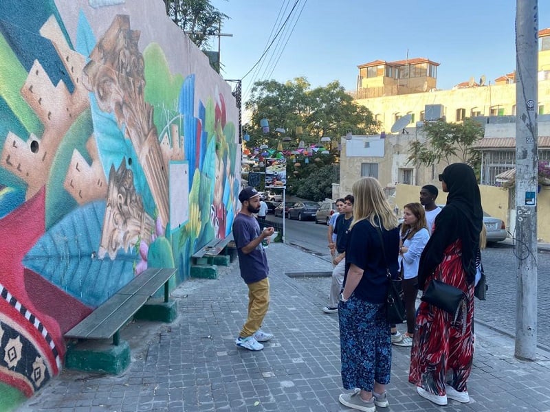 A hip-hop star and graffiti artist giving CET Jordan students a tour of downtown Amman’s street graffiti