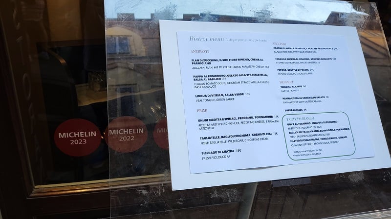 A menu outside of a Michelin star restaurant in Siena, Italy